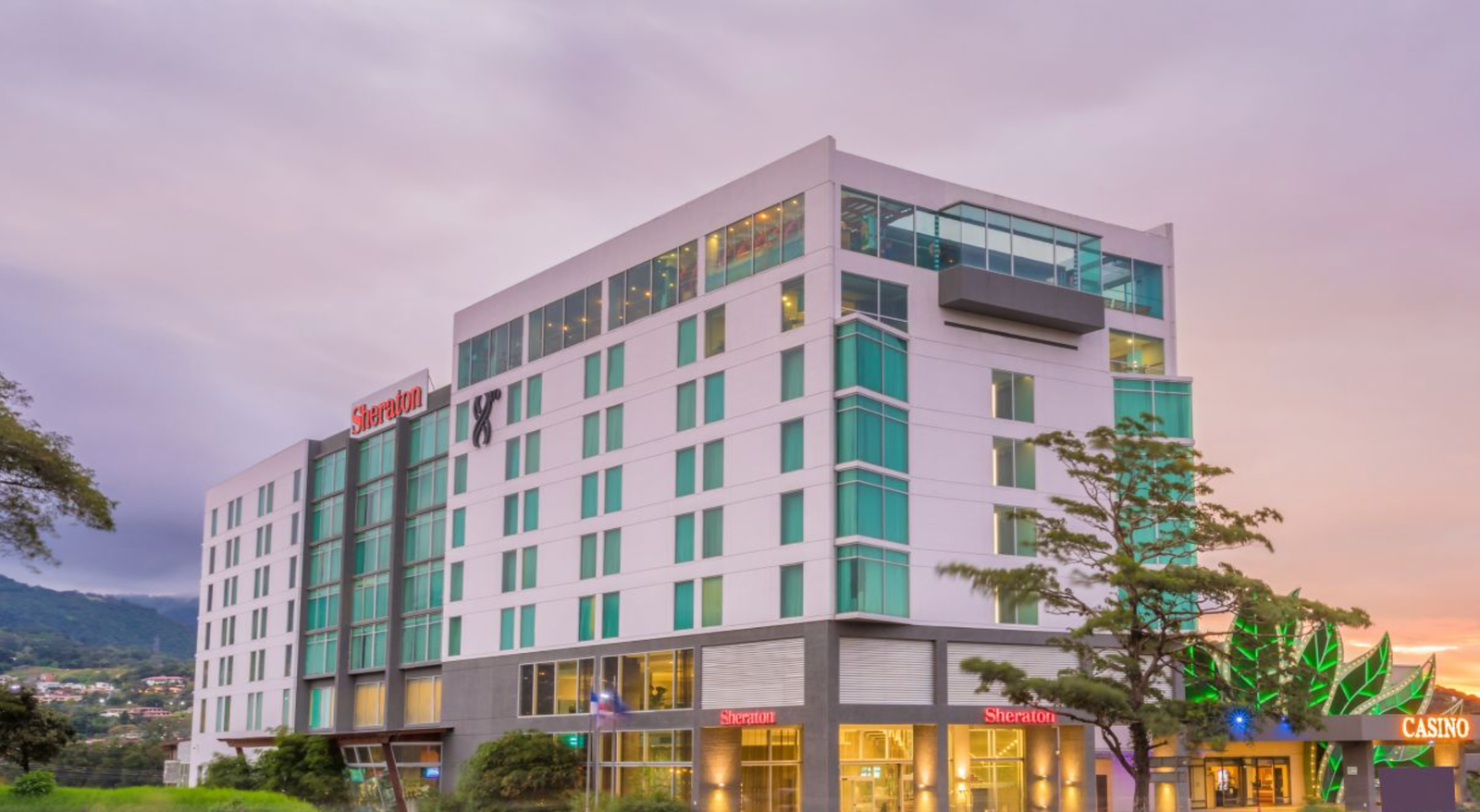 Sheraton San José hotel exterior at dusk with casino and rooftop, Costa Rica
