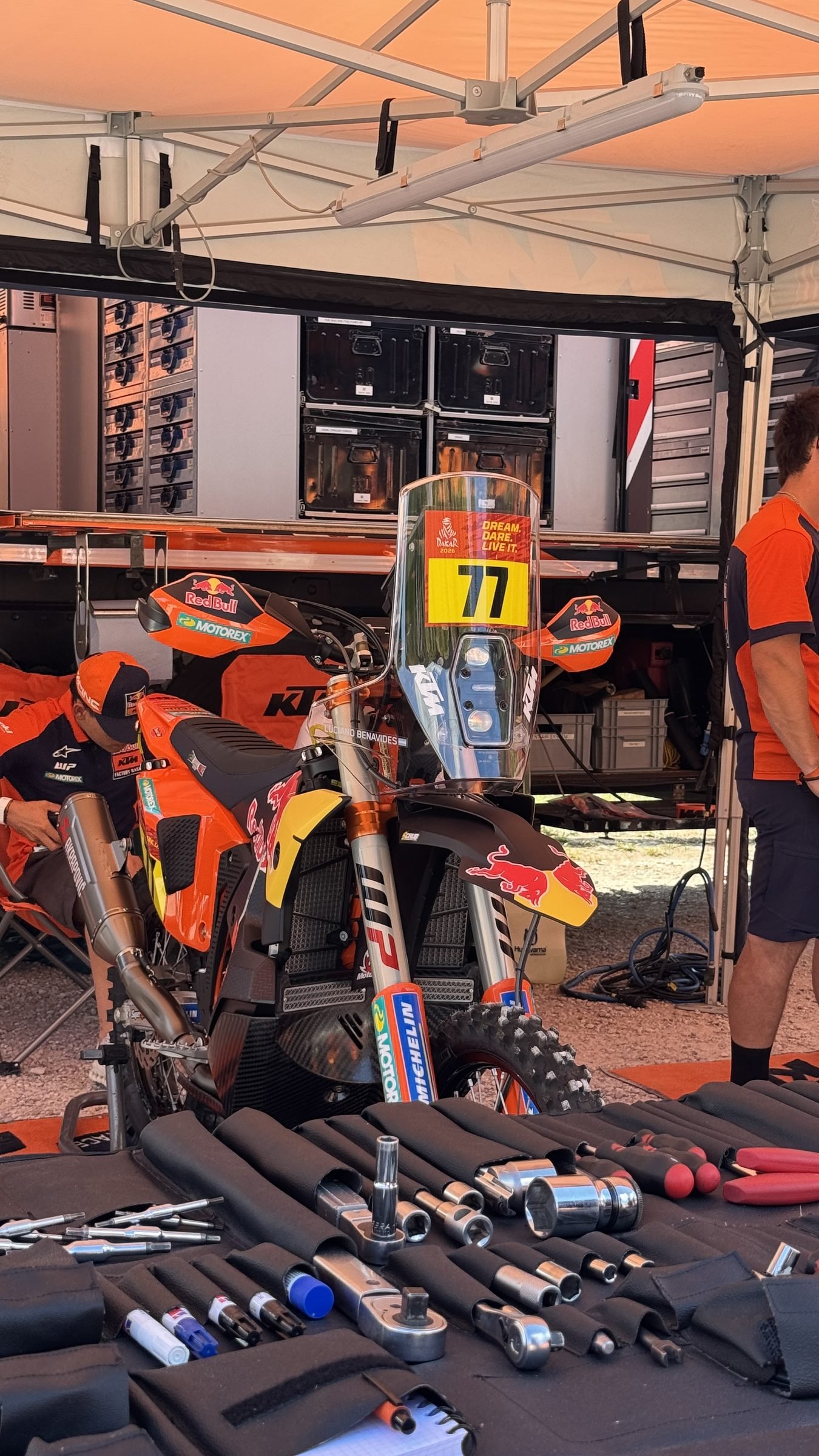 Factory KTM rally bike 77 with the mechanic's tools laid out