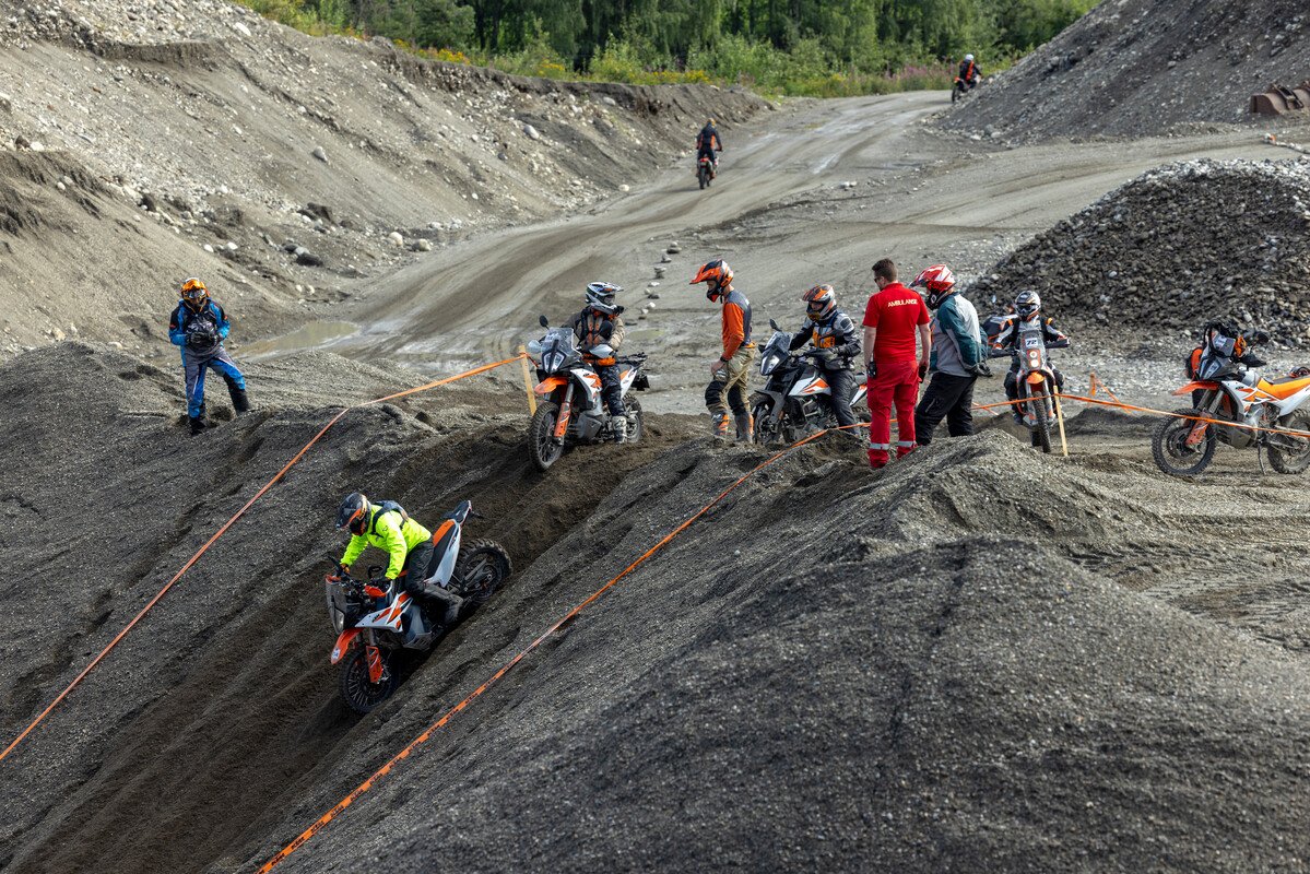 Riders tackling the hill climb gravel obstacle on Day 1