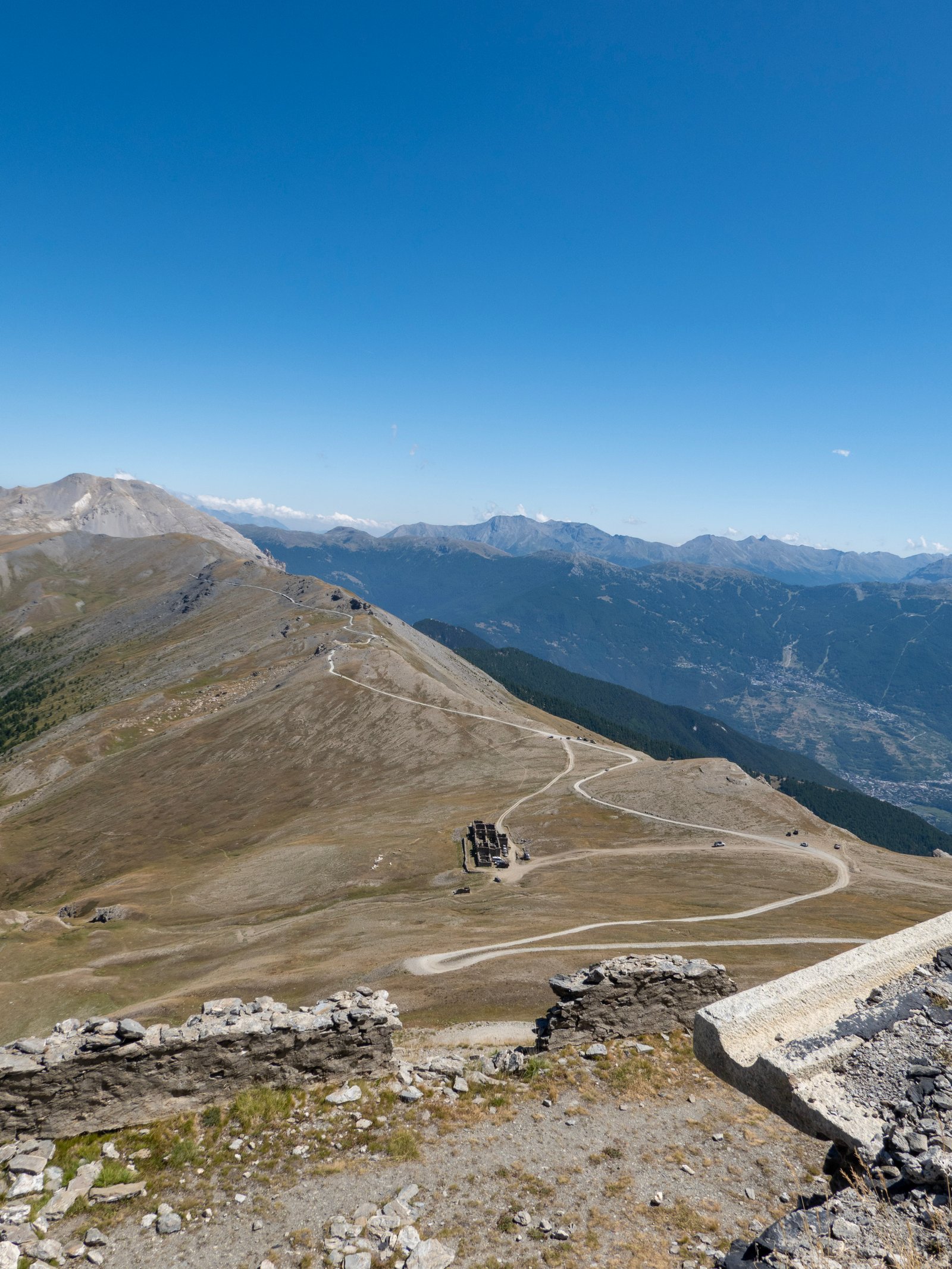 Forte Jafferau ruins and dirt access road on the ridge, Western Alps Italy