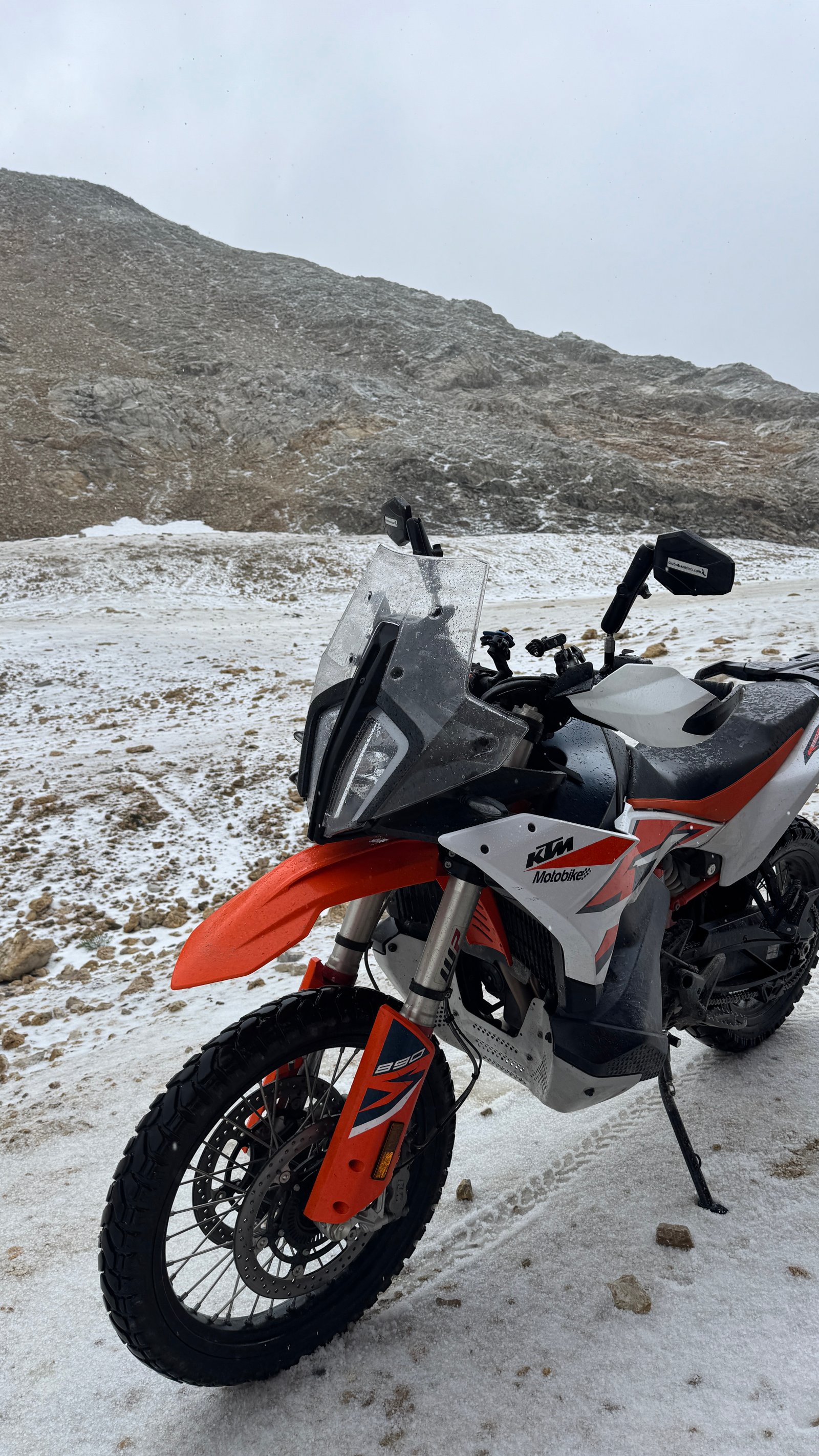 KTM 890 Adventure bike snowy alpine pass
