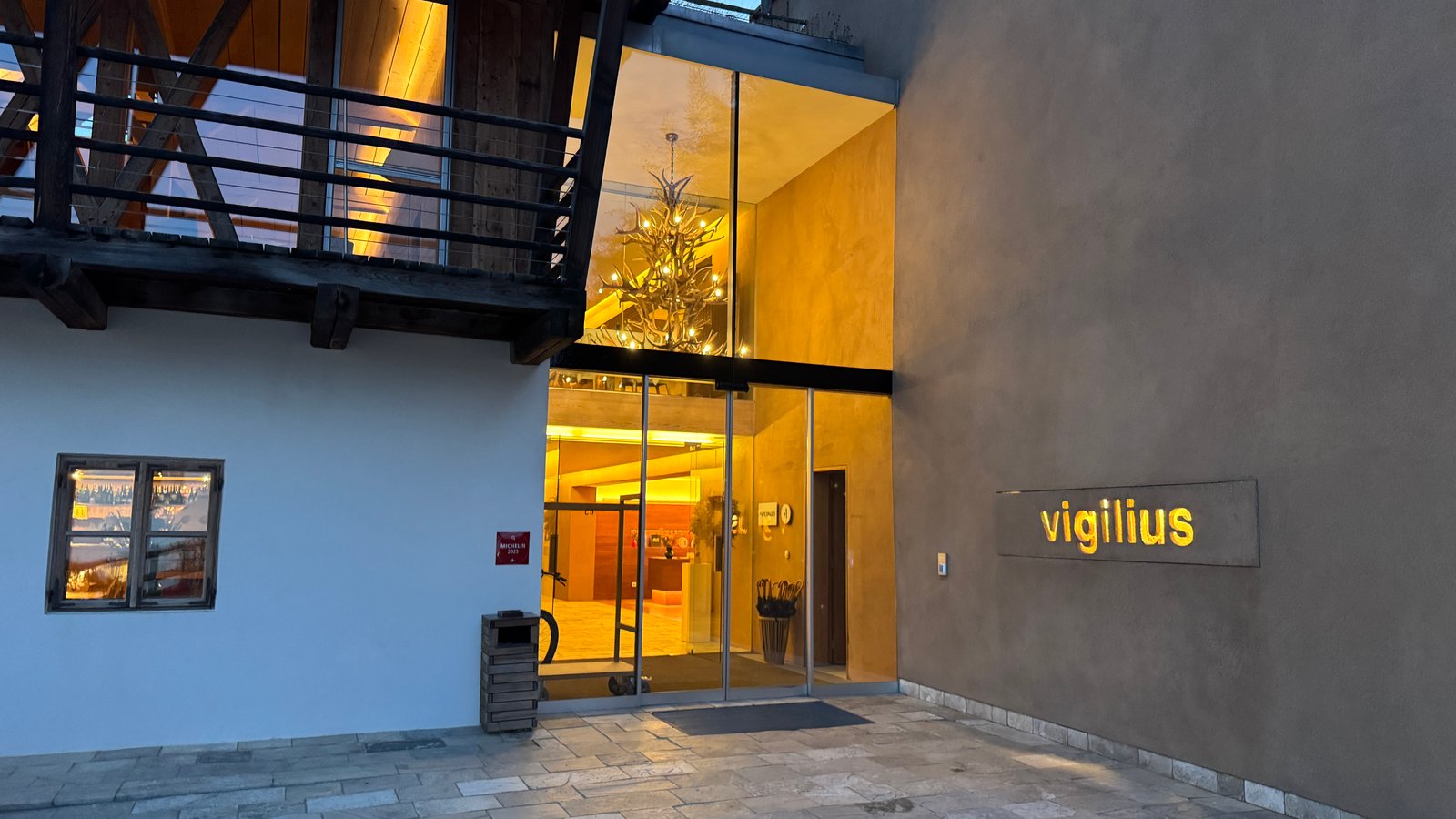 Vigilius Mountain Resort exterior at night with entrance sign, Vigiljoch