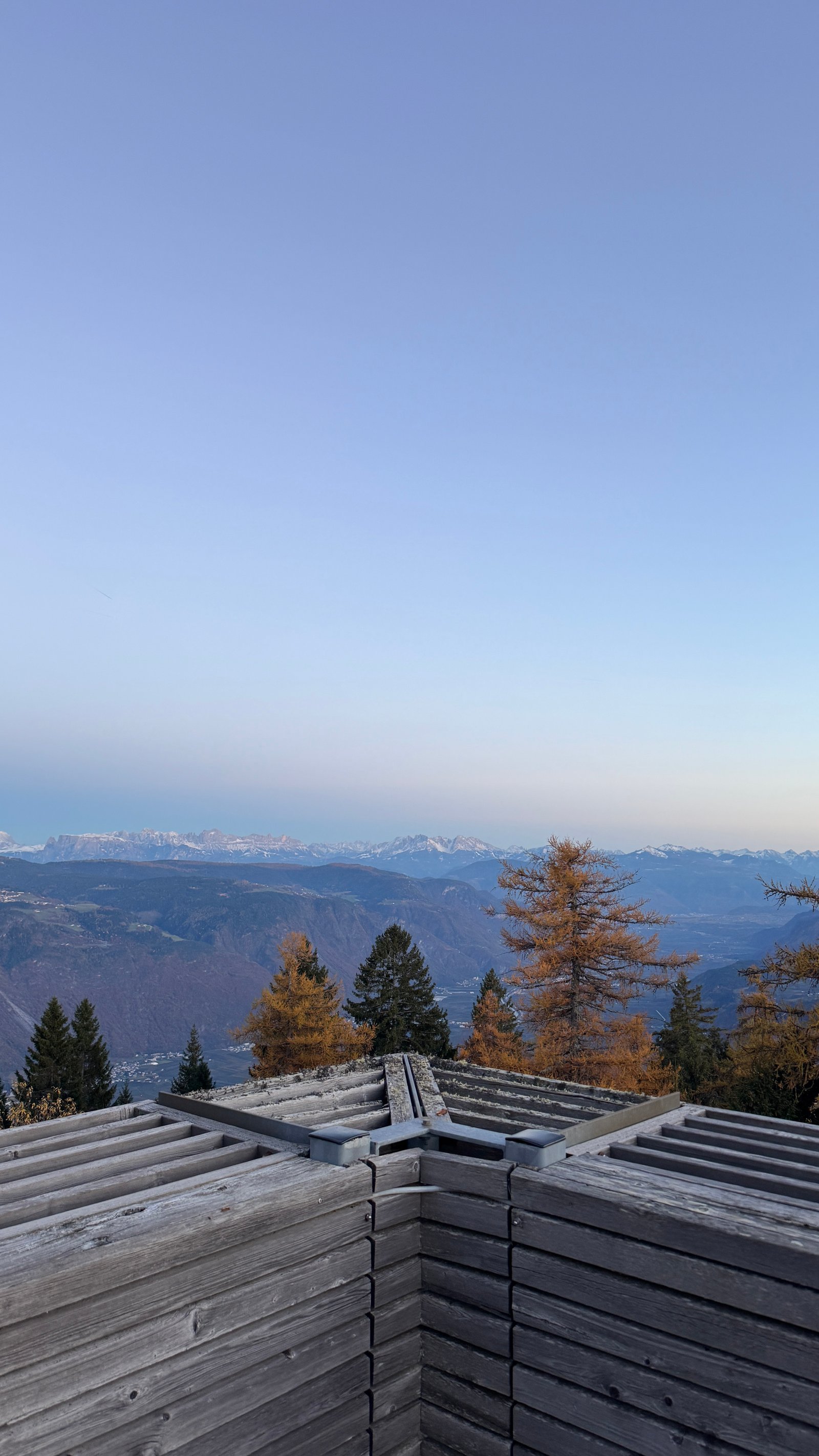 Vigilius Mountain Resort spa rooftop terrace with Dolomites view and autumn larches